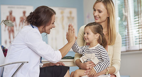Doctor highfiving a little girl