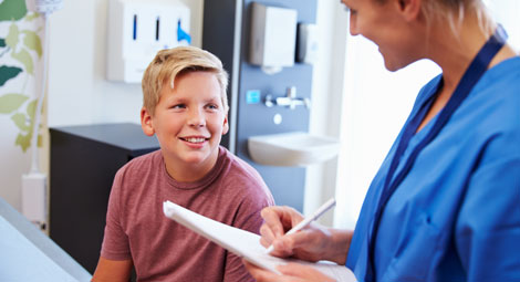 young boy talking to a doctor